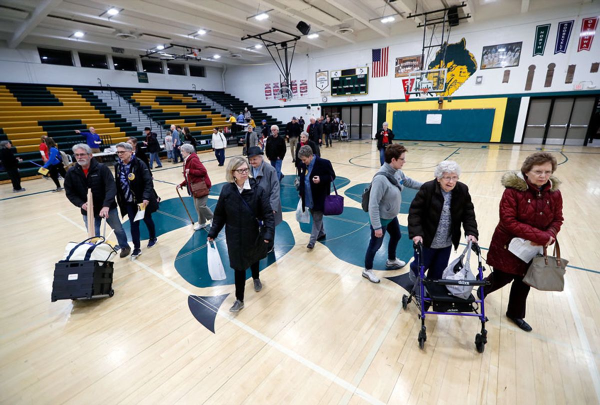 Local residents enter an Iowa Democratic caucus at Hoover High School, Monday, Feb. 3, 2020, in Des Moines, Iowa.  (AP Photo/Charlie Neibergall)