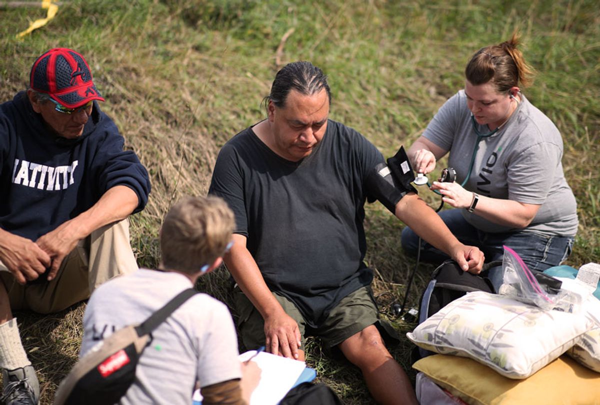 A team of nurses with Livio Health Group took the vital signs of Anthony Nichols 52, at the large homeless camp Monday September 24, 2018 in Minneapolis, MN. Nichols said that he has a heart condition and had not been taking his medicine; he was later transported to local hospital by ambulance. Nichols said that he had been staying at the camp for only two days.  (Jerry Holt/Star Tribune via Getty Images)