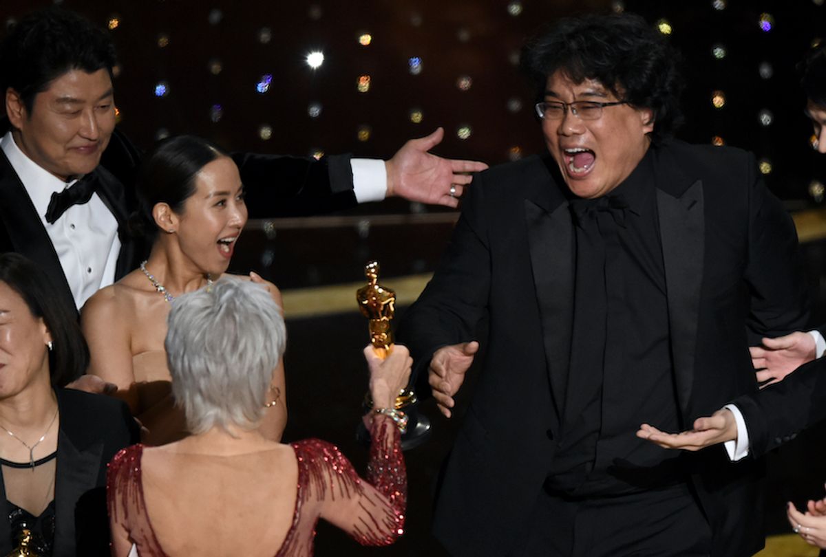 Bong Joon-ho, right, reacts as he is presented with the award for best picture for "Parasite" from presenter Jane Fonda at the Oscars on Sunday, Feb. 9, 2020. Looking on from left are Kang-Ho Song and Kwak Sin Ae. (AP Photo/Chris Pizzello)