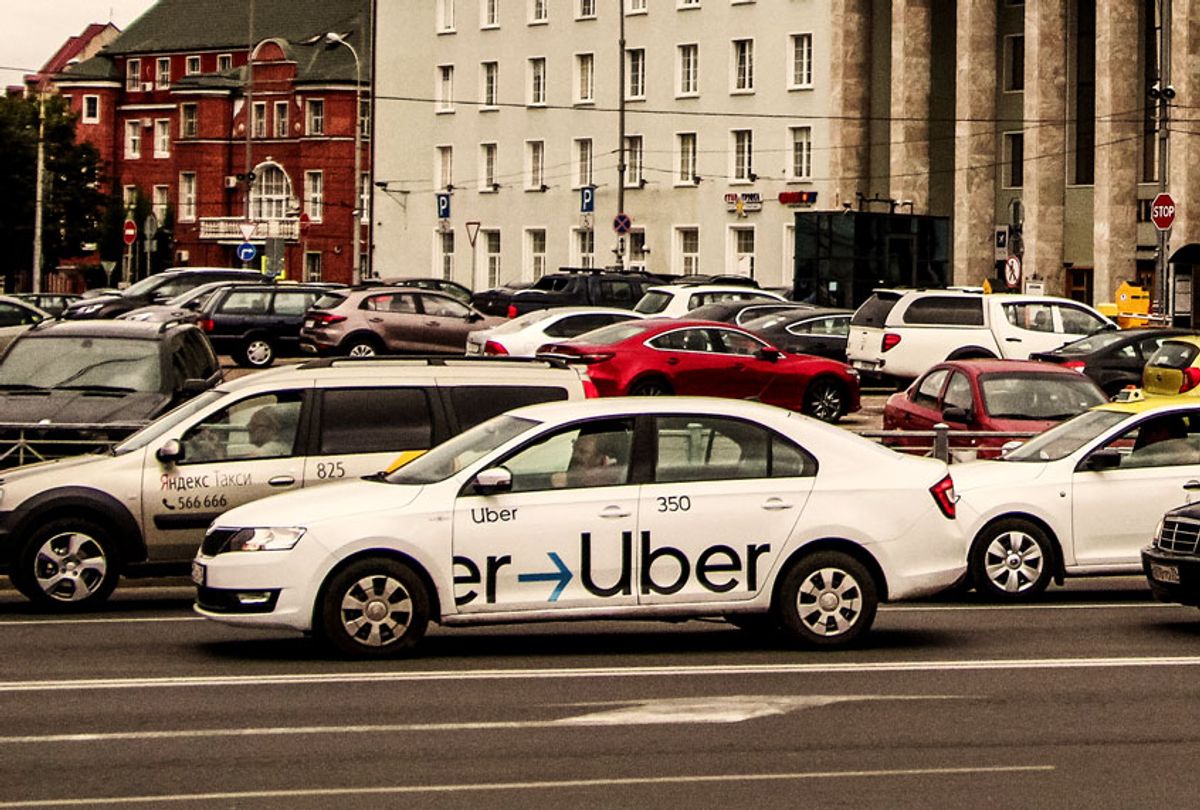 Uber driver driving a logo branded car (Michal Fludra/NurPhoto via Getty Images)