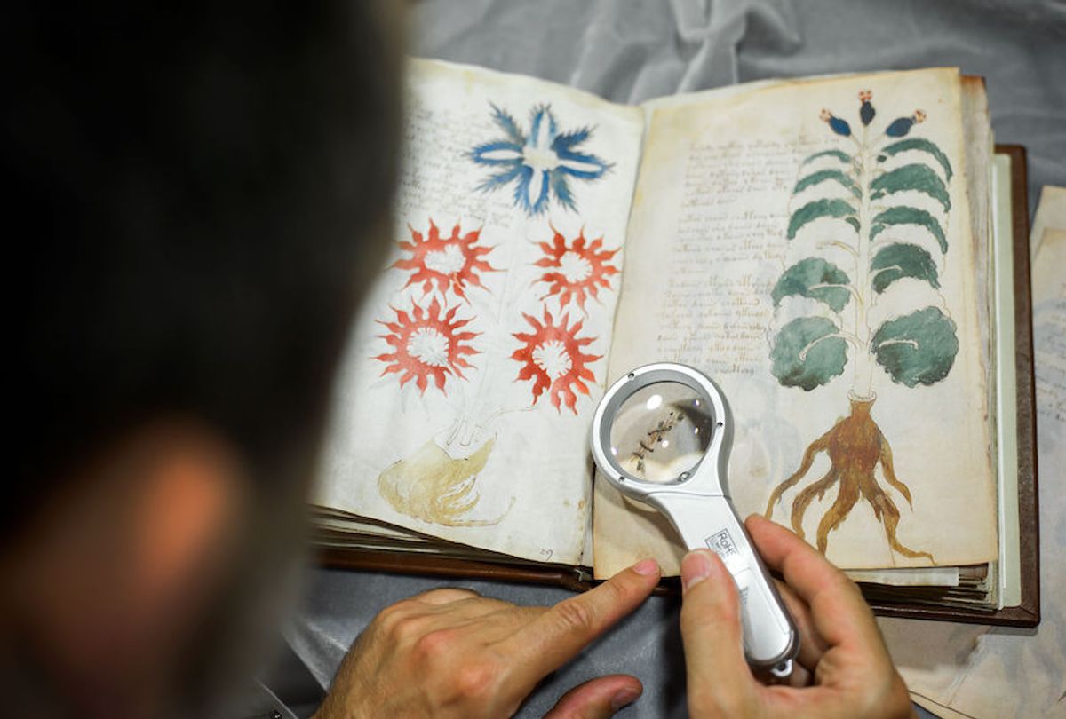 Quality control operator of the Spanish publishing outfit Siloe Luis Miguel works on cloning the illustrated codex hand-written manuscript Voynich in Burgos on August 9, 2016.  (Cesar Manso/AFP via Getty)