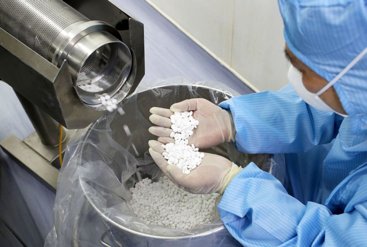 An employee checks the production of chloroquine phosphate (Feature China/Barcroft Media via Getty Images)