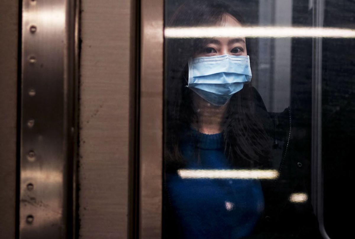 A woman wears a medical mask on the subway as New York City confronts the coronavirus outbreak on March 11, 2020 in New York City. President Donald Trump announced on Wednesday evening that he is restricting passenger travel from 26 European nations to the U.S. in an effort to contain the coronavirus which is rapidly spreading throughout the world and America. (Spencer Platt/Getty Images)