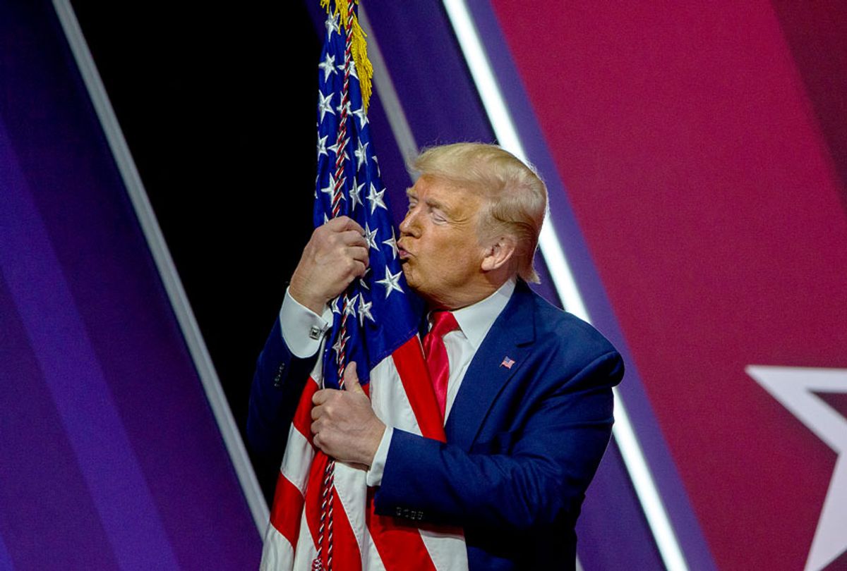 President Donald Trump kisses the flag of the United States of America (Tasos Katopodis/Getty Images)