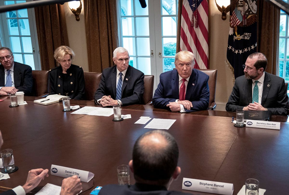 Flanked by U.S. Vice President Mike Pence (L) and Secretary of Health and Human Services Alex Azar, U.S. President Donald Trump leads a meeting with the White House Coronavirus Task Force and pharmaceutical executives in Cabinet Room of the White House on March 2, 2020 in Washington, DC. President Trump and his Coronavirus Task Force team met with pharmaceutical companies representatives who are actively working to develop a COVID-19 vaccine.  (Drew Angerer/Getty Images)