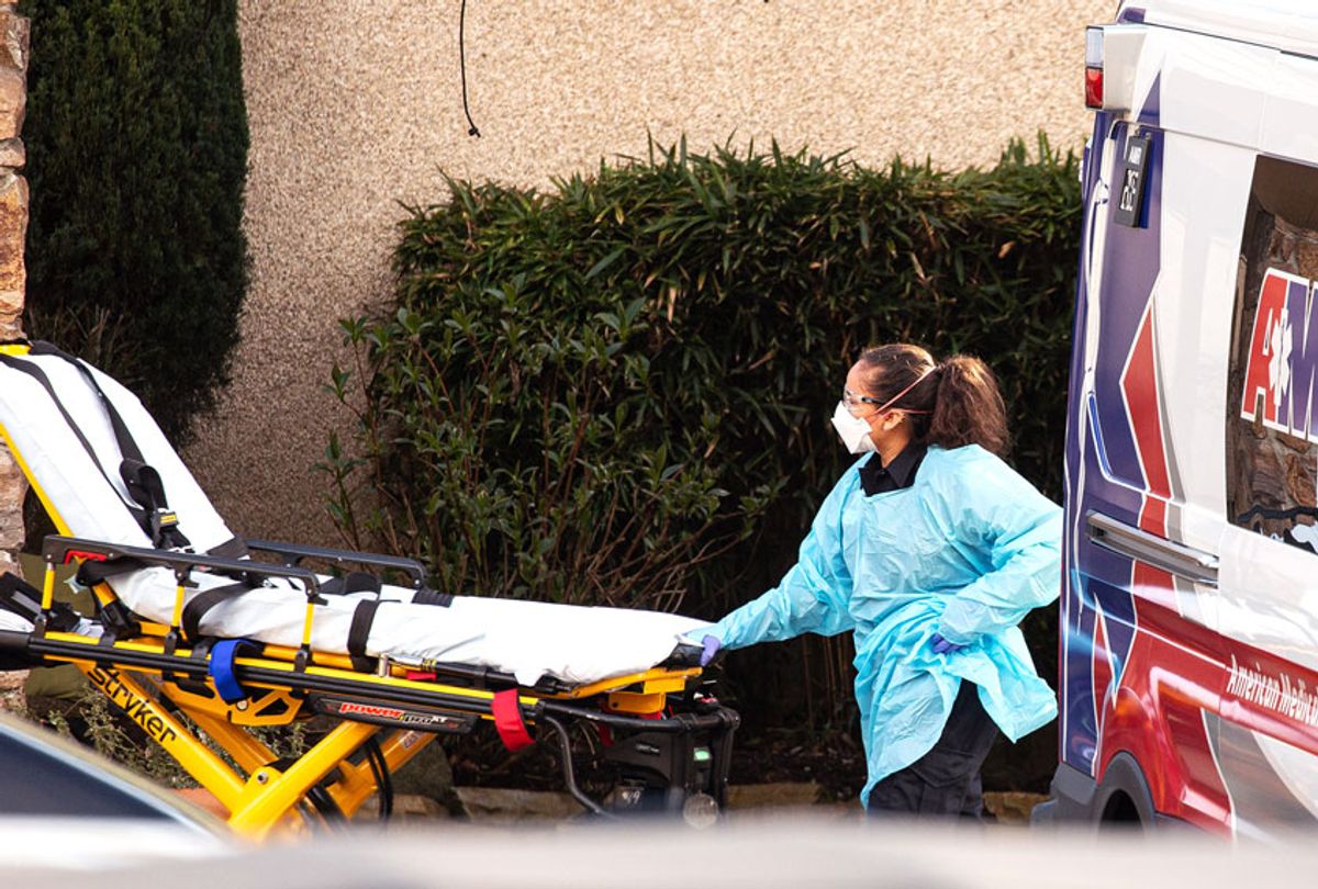 A healthcare worker prepares to transport a patient on a stretcher into an ambulance at Life Care Center of Kirkland on February 29, 2020 in Kirkland, Washington. Dozens of staff and residents at Life Care Center of Kirkland are reportedly exhibiting coronavirus-like symptoms, with two confirmed cases of (COVID-19) associated with the nursing facility reported so far.  (David Ryder/Getty Images)
