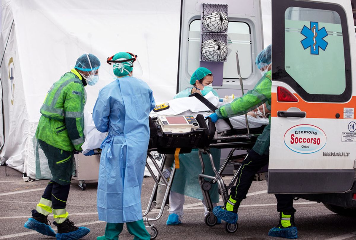 Medical personnel transport the first patient affected by COVID-19 to an ICU tent ( Emanuele Cremaschi/Stringer/Getty Images)