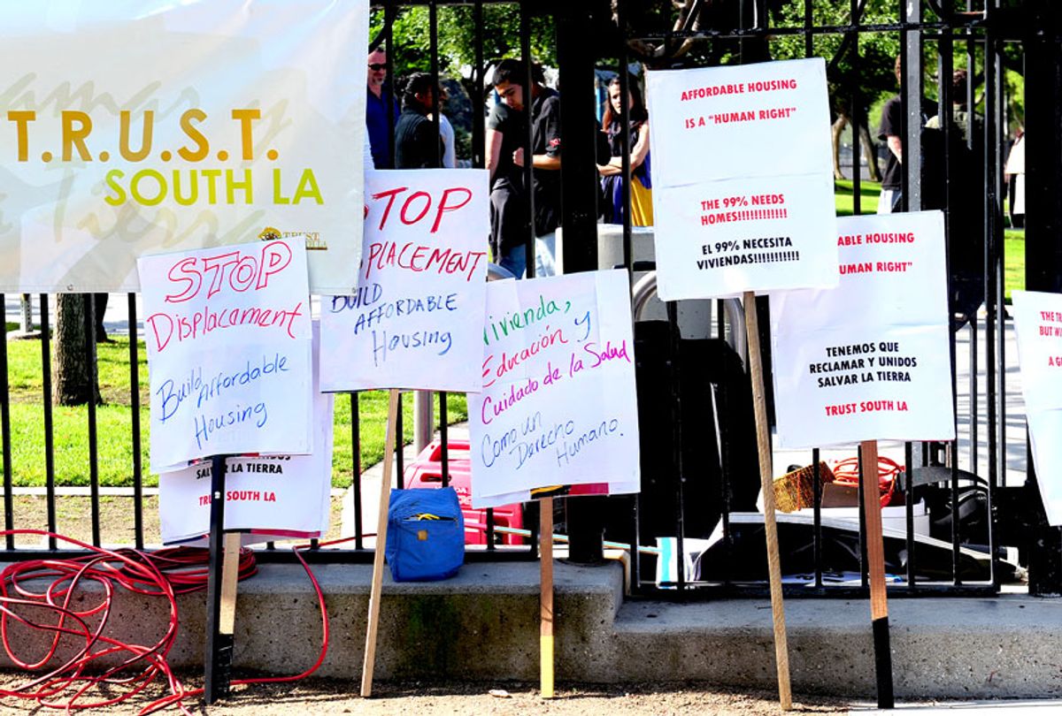 Placards expressing neighborhood concerns of rising rents and housing displacement. (FREDERIC J. BROWN/AFP/GettyImages)