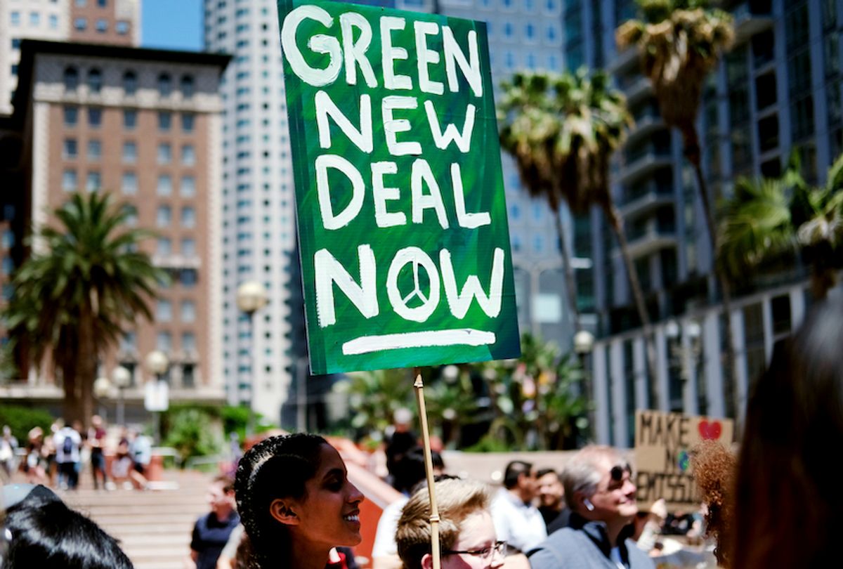 Climate change activists holding signs join in on a rally supporting the "Green New Deal" in Pershing Square in downtown Los Angeles on Friday, May 24, 2019.  (AP Photo/Richard Vogel)