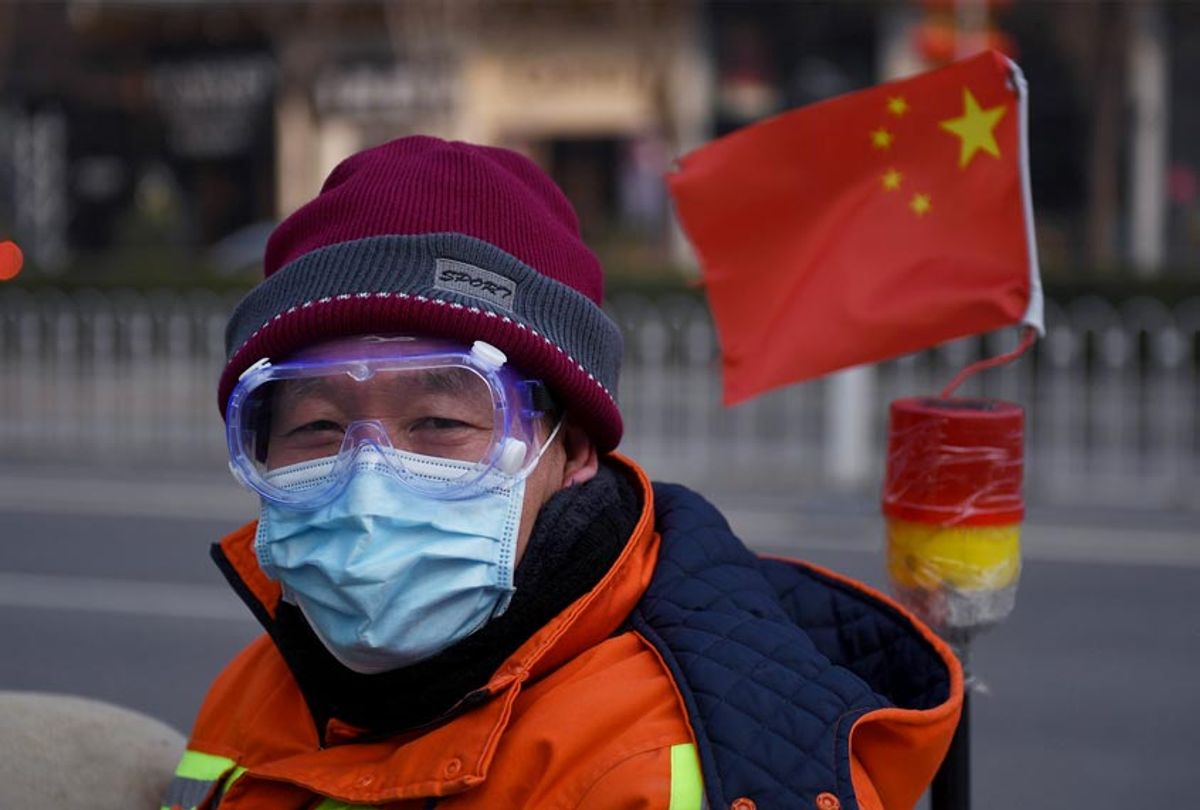 A man wears a mask and goggles as he commutes on a street in Beijing (GREG BAKER/AFP via Getty Images)