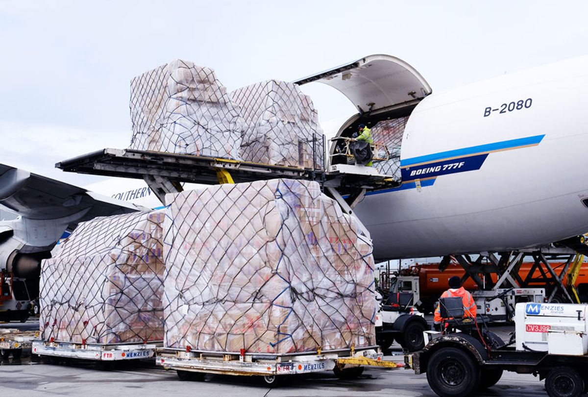 Ground crew at the Los Angeles International airport unload pallets of supplies of medical personal protective equipment, PPE, from a China Southern Cargo plane upon its arrival on Friday, April 10, 2020.  (AP Photo/Richard Vogel)