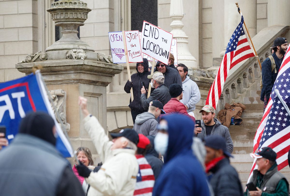 People gather on the Capitol's steps to express their unhappiness with Governor Gretchen Whitmer's Stay Safe, Stay Home executive order on April 15, 2020 in Lansing, Michigan.  (Elaine Cromie/Getty Images)