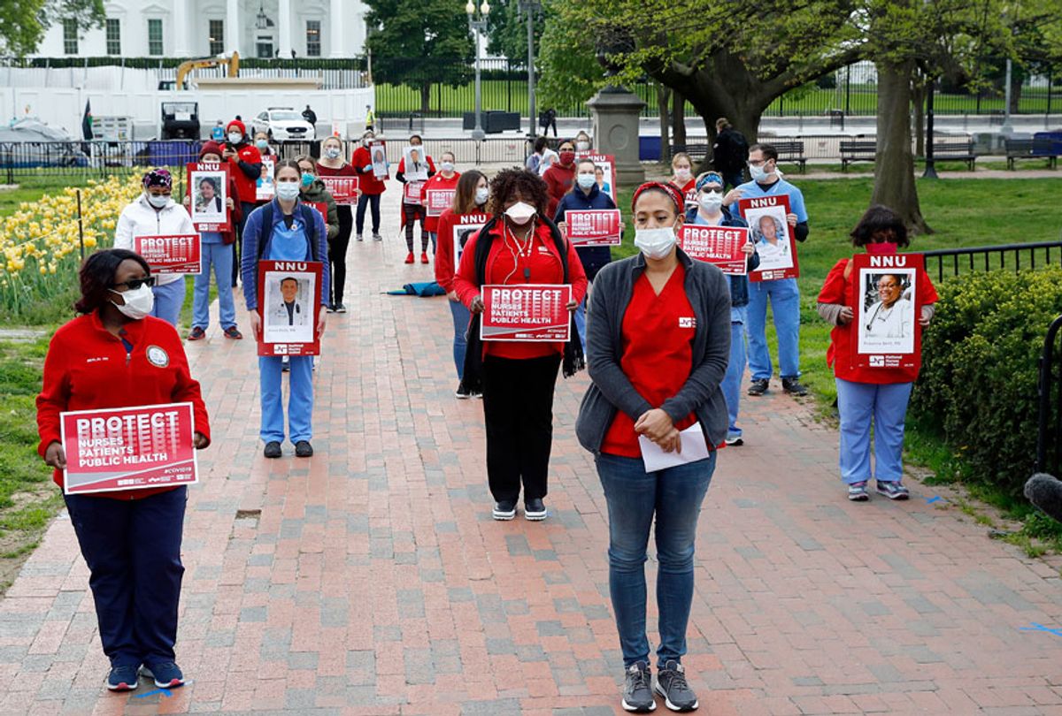 Nurses from National Nurses United practice social distancing as they protest in front of the White House, Tuesday, April 21, 2020, in Washington. (AP Photo/Patrick Semansky)