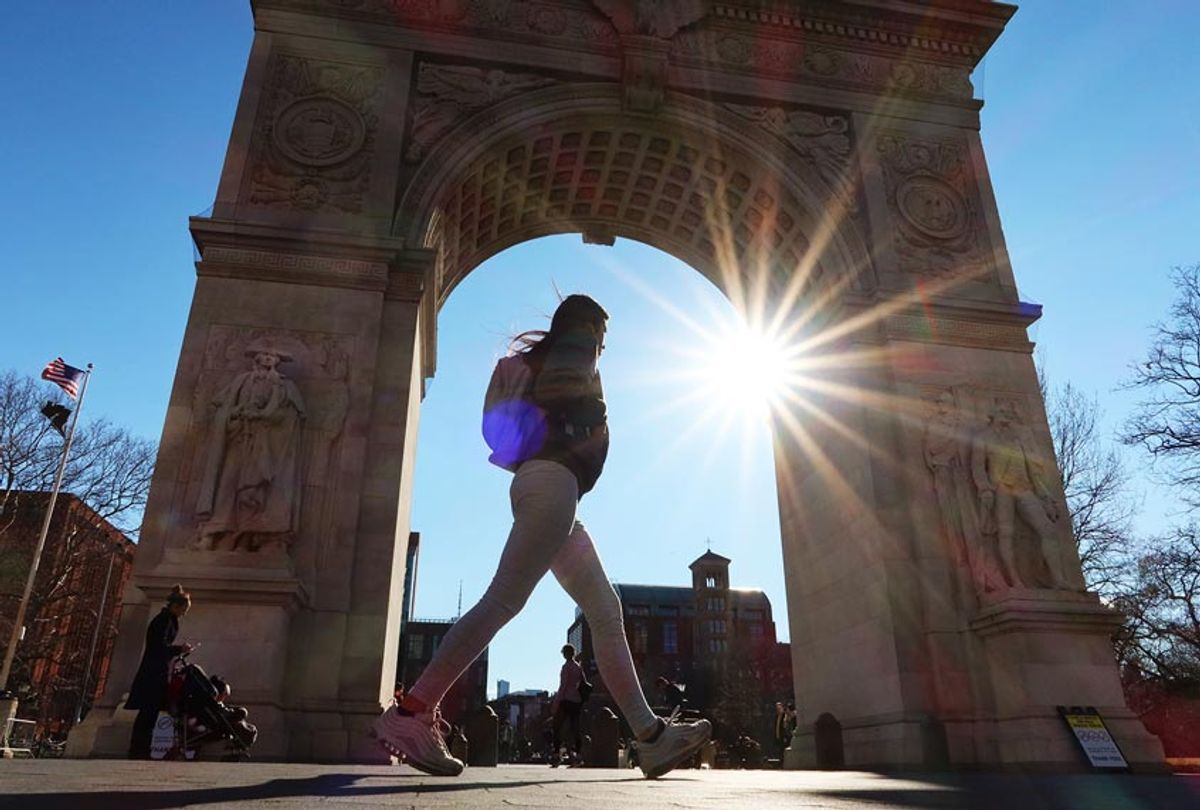 A person walks past the arch in Washington Square Park on March 4, 2020 in New York City. (Gary Hershorn/Corbis via Getty Images)