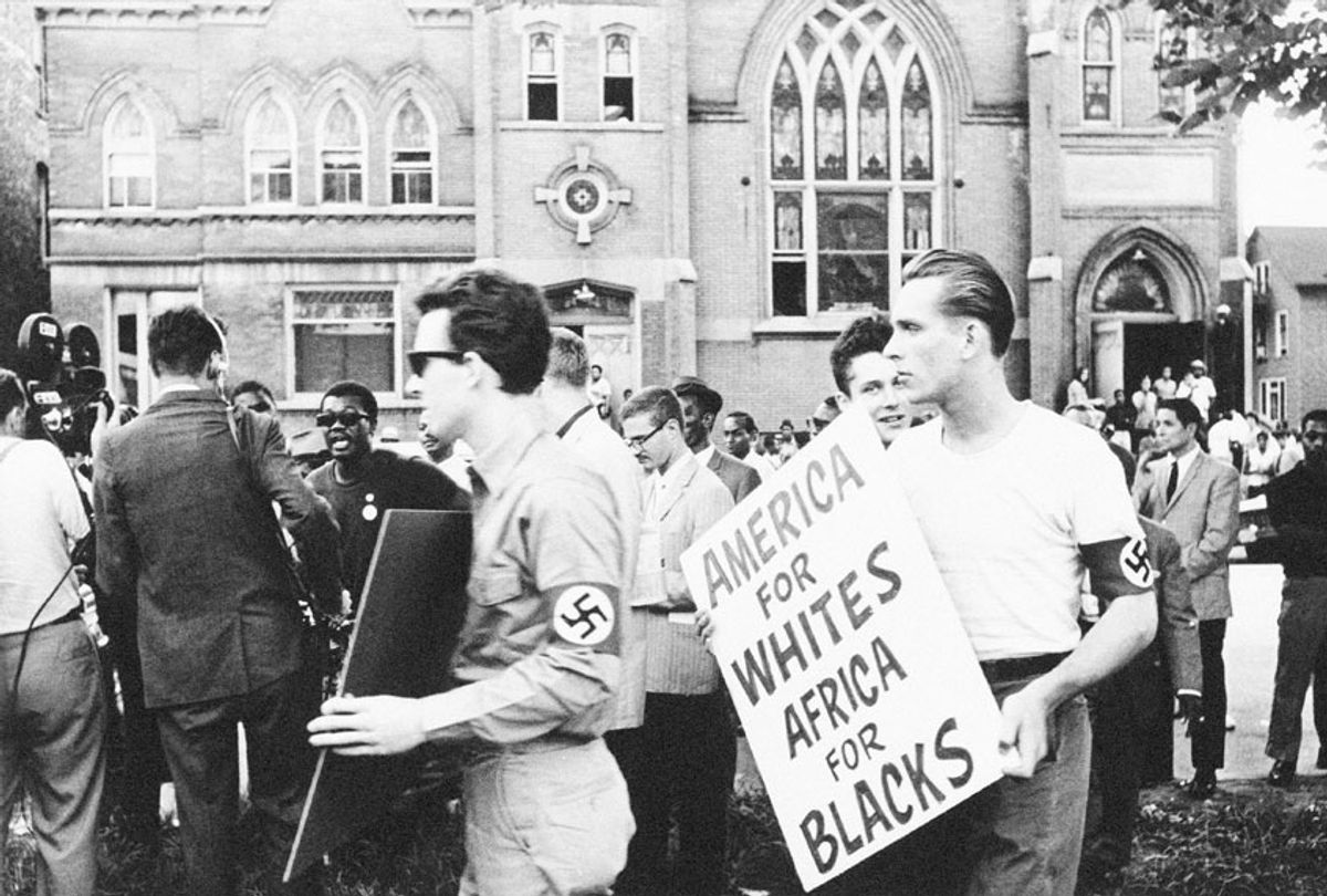 Members of the American Nazi Party march with signs across the street from the Greater Mount Hope Baptist Church on the south side of Chicago, Ill. on, August 19, 1966 (AP Photo/ Larry Stoddard)