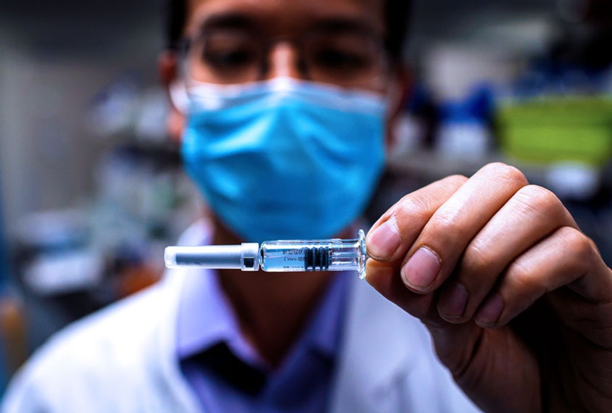 An engineer shows an experimental vaccine for the COVID-19 coronavirus (NICOLAS ASFOURI/AFP via Getty Images)
