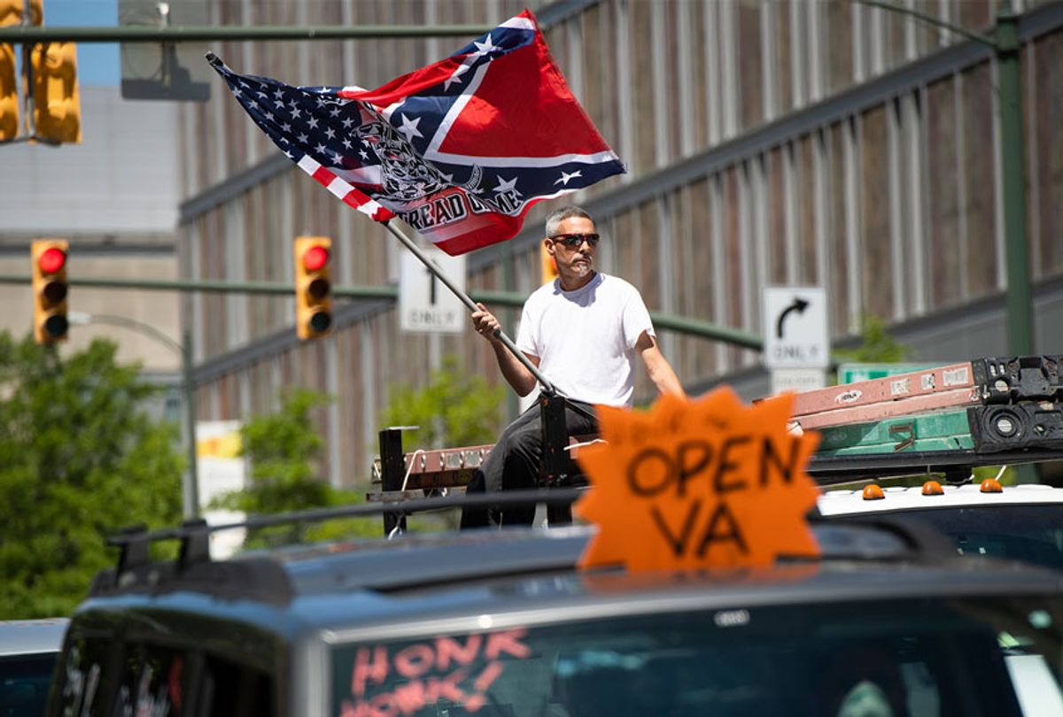Demonstrators are seen near Capitol Square during a rally to demand that Gov. Ralph Northam (D) lift restrictions that have closed certain businesses in Virginia since the coronavirus outbreak  (Tom Williams/CQ-Roll Call, Inc via Getty Images)