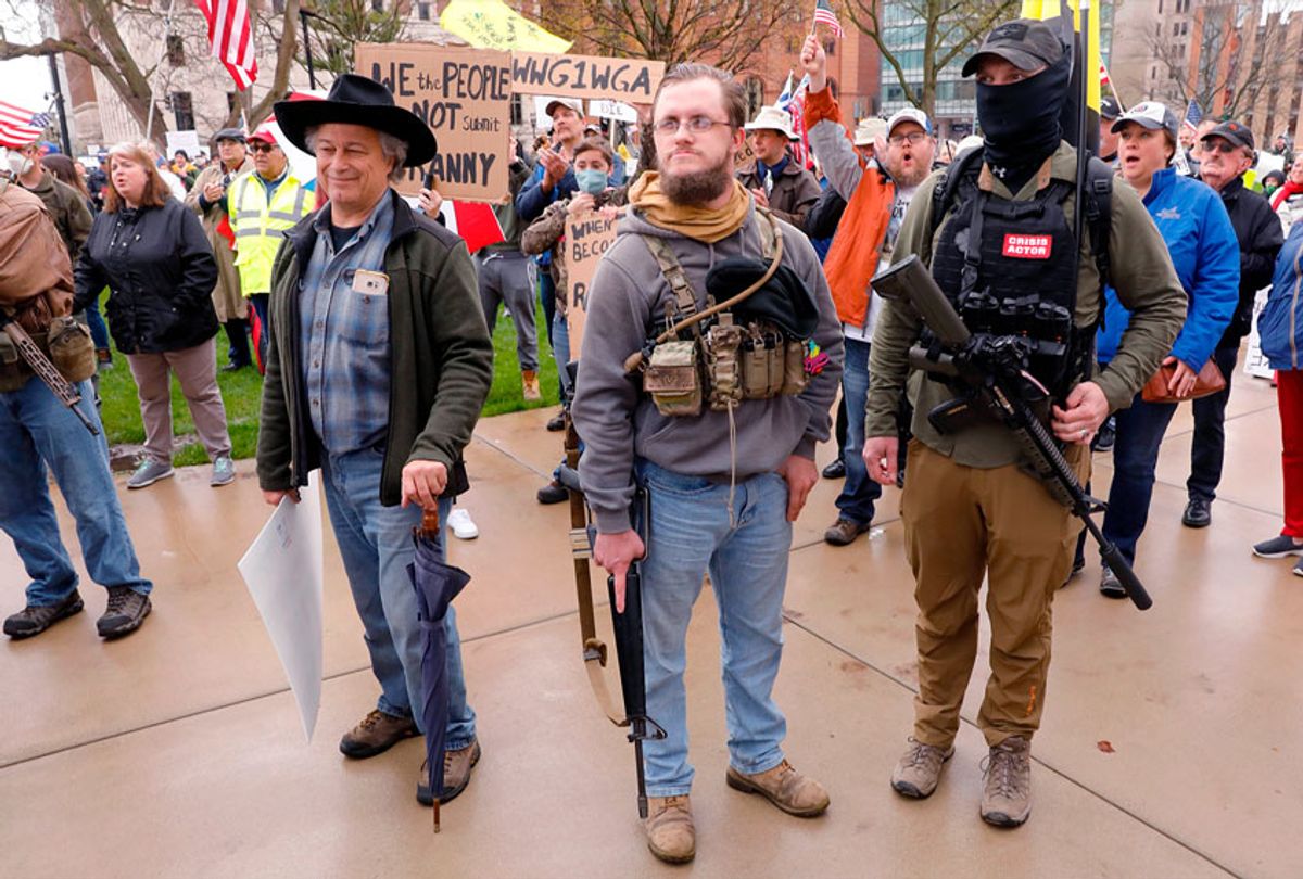 Armed protesters on the steps of the Michigan State Capitol in Lansing, demanding the reopening of businesses (JEFF KOWALSKY/AFP via Getty Images)