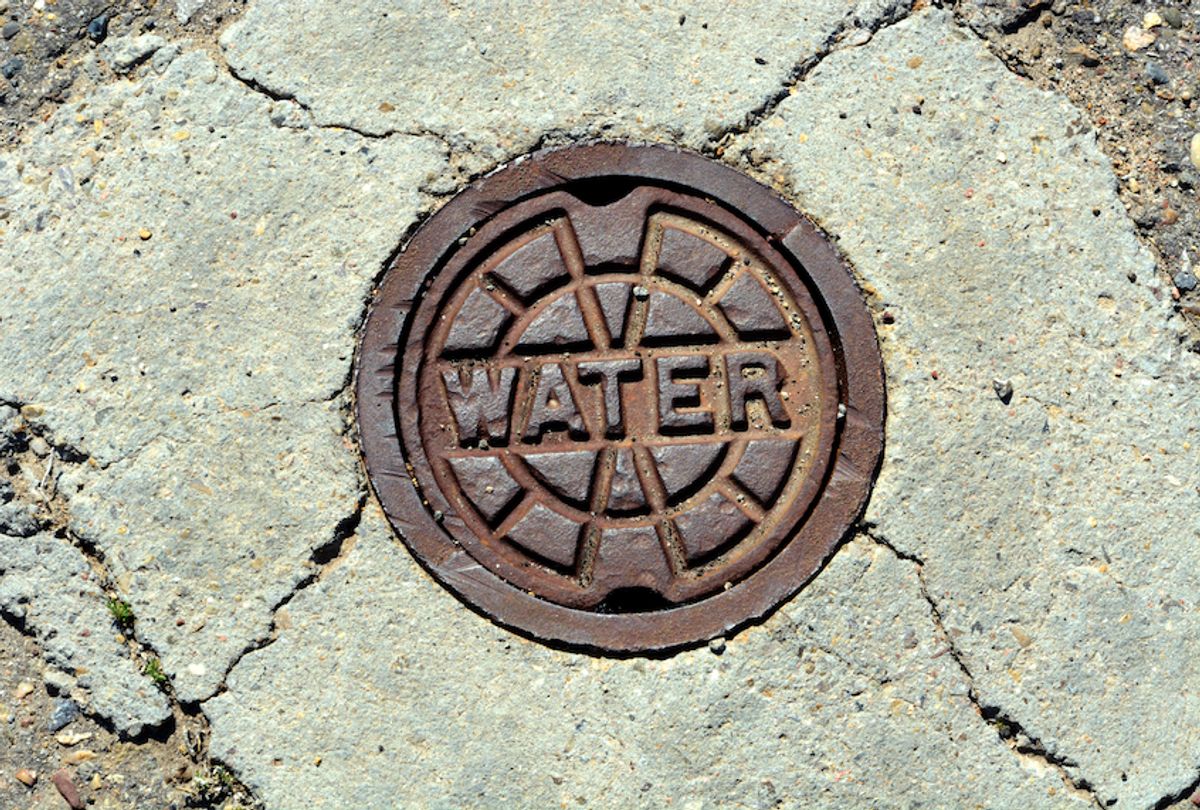 A water main manhole cover in a street in Santa Fe, New Mexico. (Robert Alexander/Getty Images)