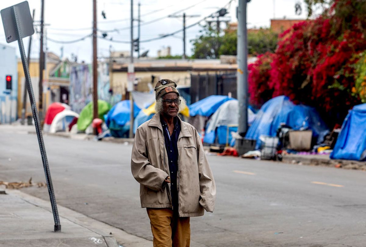 A homeless person walks on San Julian Street in the Skid Row area in downtown Los Angeles, California on March 19, 2020 (APU GOMES/AFP via Getty Images)