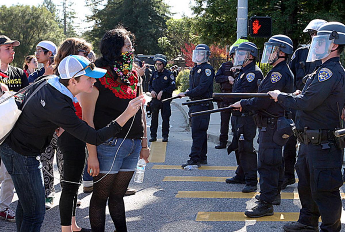 University of California police contain demonstrators Wednesday at the intersection of Bay and High streets, an entrance to the UC Santa Cruz campus. (Dan Coyro/Santa Cruz Sentinel)
