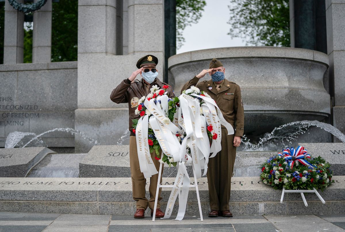 (L-R) Vietnam War veteran C. Patrick McCourt and retired U.S. Air Force Lt. Col. Sidney Wade salute as they participate in a wreath laying ceremony to mark the 75th anniversary of the Allied victory in Europe at the National World War II Memorial on May 8, 2020 in Washington, DC. (Drew Angerer/Getty Images)