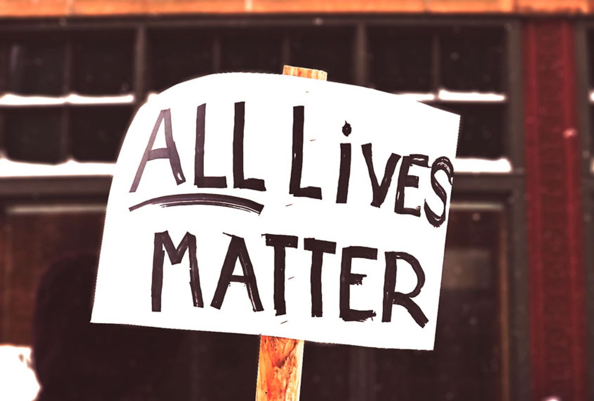 Protester holds an "All lives matter" sign (Getty Images)