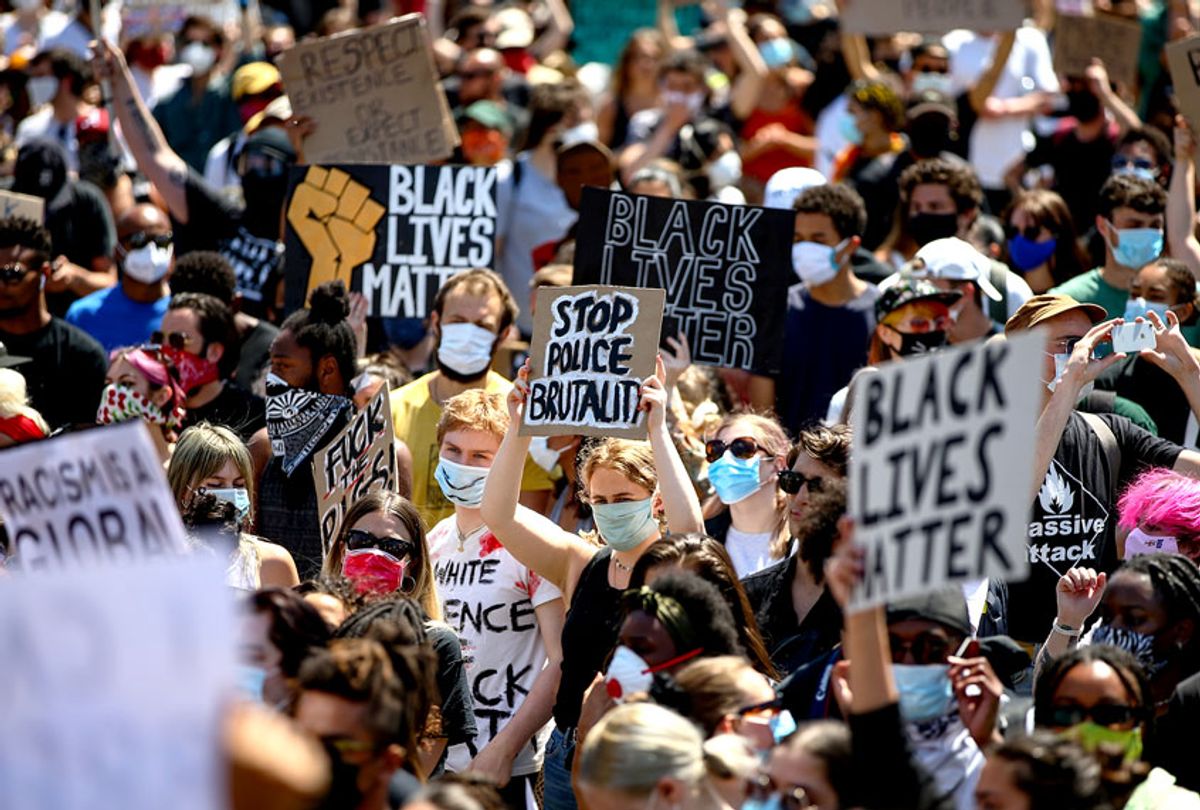 People hold placards as they join a spontaneous Black Lives Matter march to protest the death of George Floyd in Minneapolis  (Hollie Adams/Getty Images)