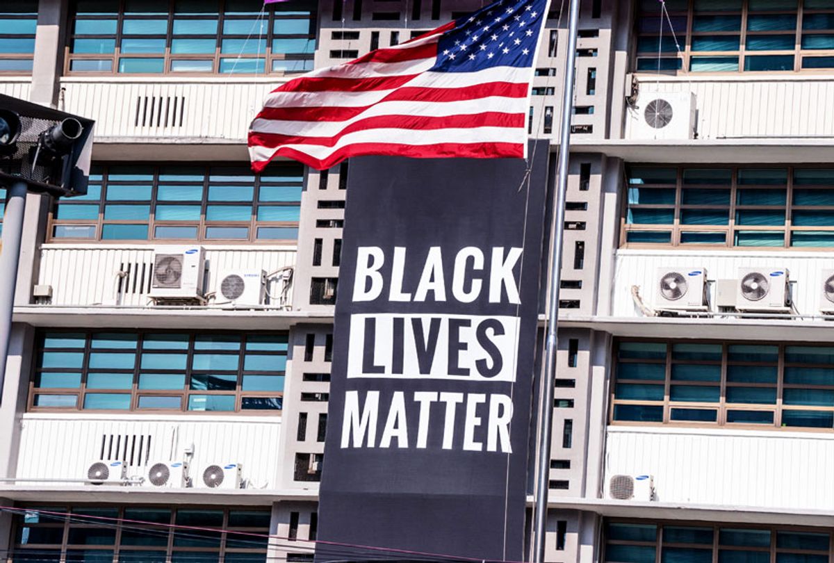 A Black Lives Matter banner, a United States national flag and a rainbow flag are hung on the facade of the US embassy building in Seoul. (Getty Images/imon Shin/SOPA Images/LightRocket)