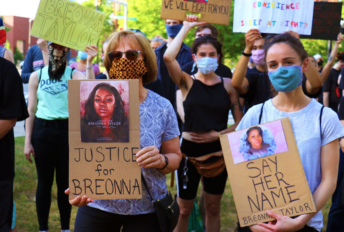 Two women hold signs with Breonna Taylor's photo at a vigil held in Boston's Nubian Square on June 5, 2020 in honor of Breonna Taylor, a black woman shot to death by Loisville, KY police on March 13. (John Tlumacki/The Boston Globe via Getty Images)