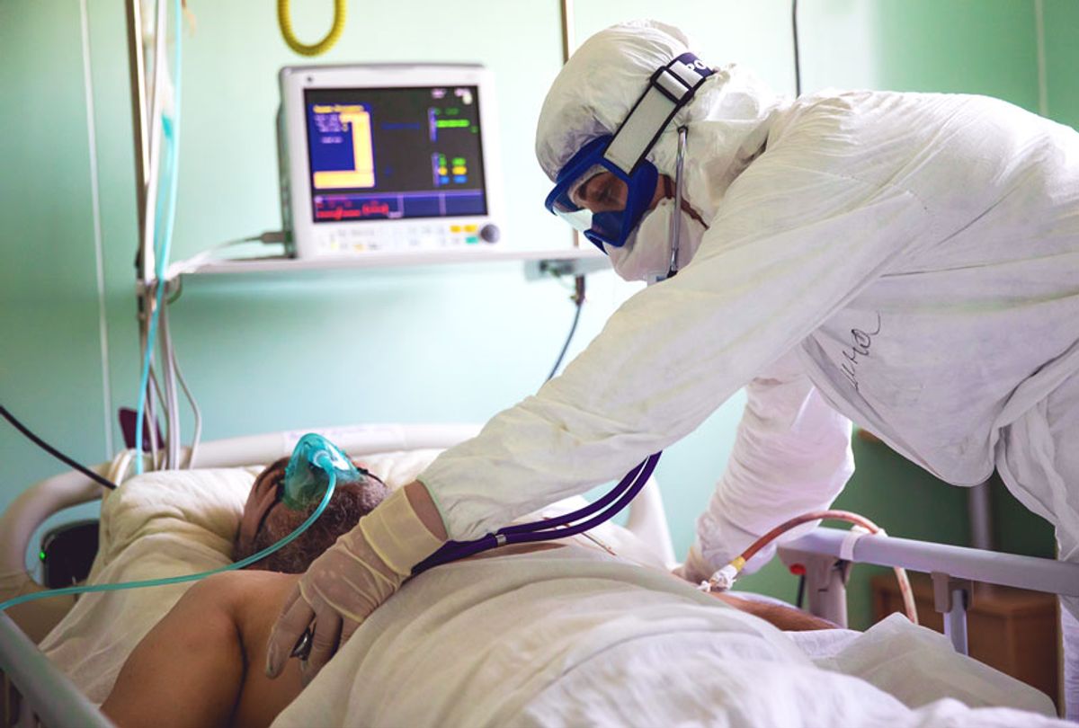 A medical staff member attends a patient in an intensive care unit for COVID-19 patients (Yelena Afonina\TASS via Getty Images)