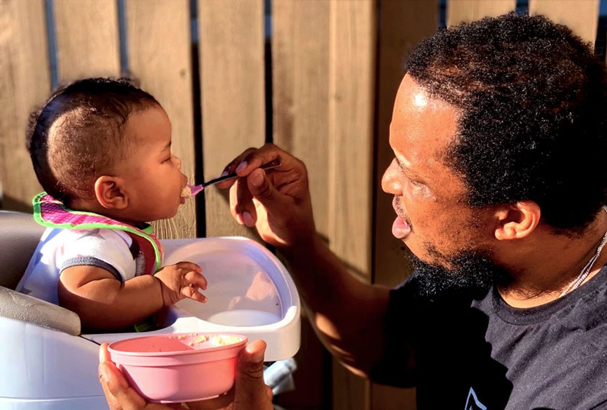 Dwight Watkins feeding his daughter (Photo provided by Dwight Watkins)