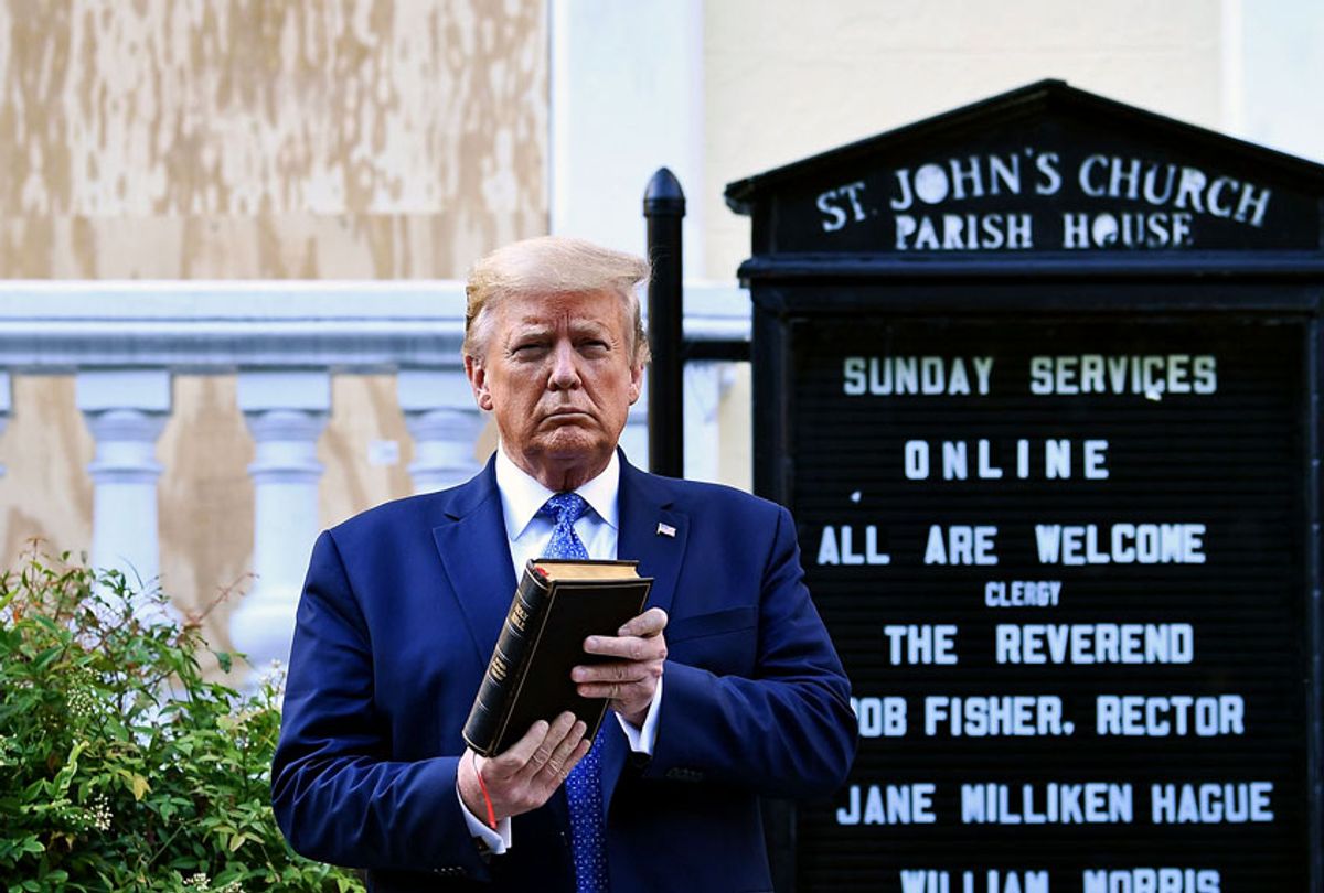 US President Donald Trump holds up a Bible outside of St John's Episcopal church across Lafayette Park in Washington, DC on June 1, 2020. (BRENDAN SMIALOWSKI/AFP via Getty Images)