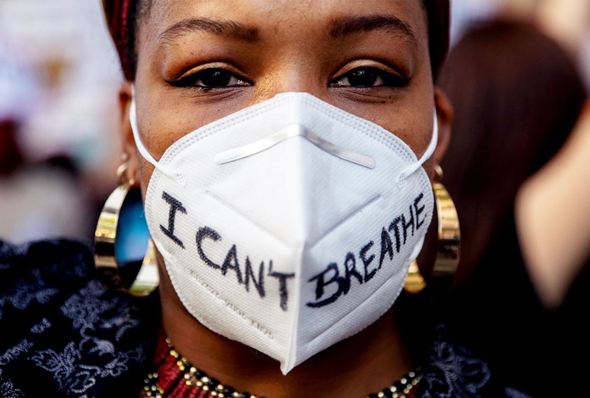 A demonstrator wears a protective mask reading 'I can't breath' during a Black Lives Matter protest following the death of George Floyd (Pablo Blazquez Dominguez/Getty Images)