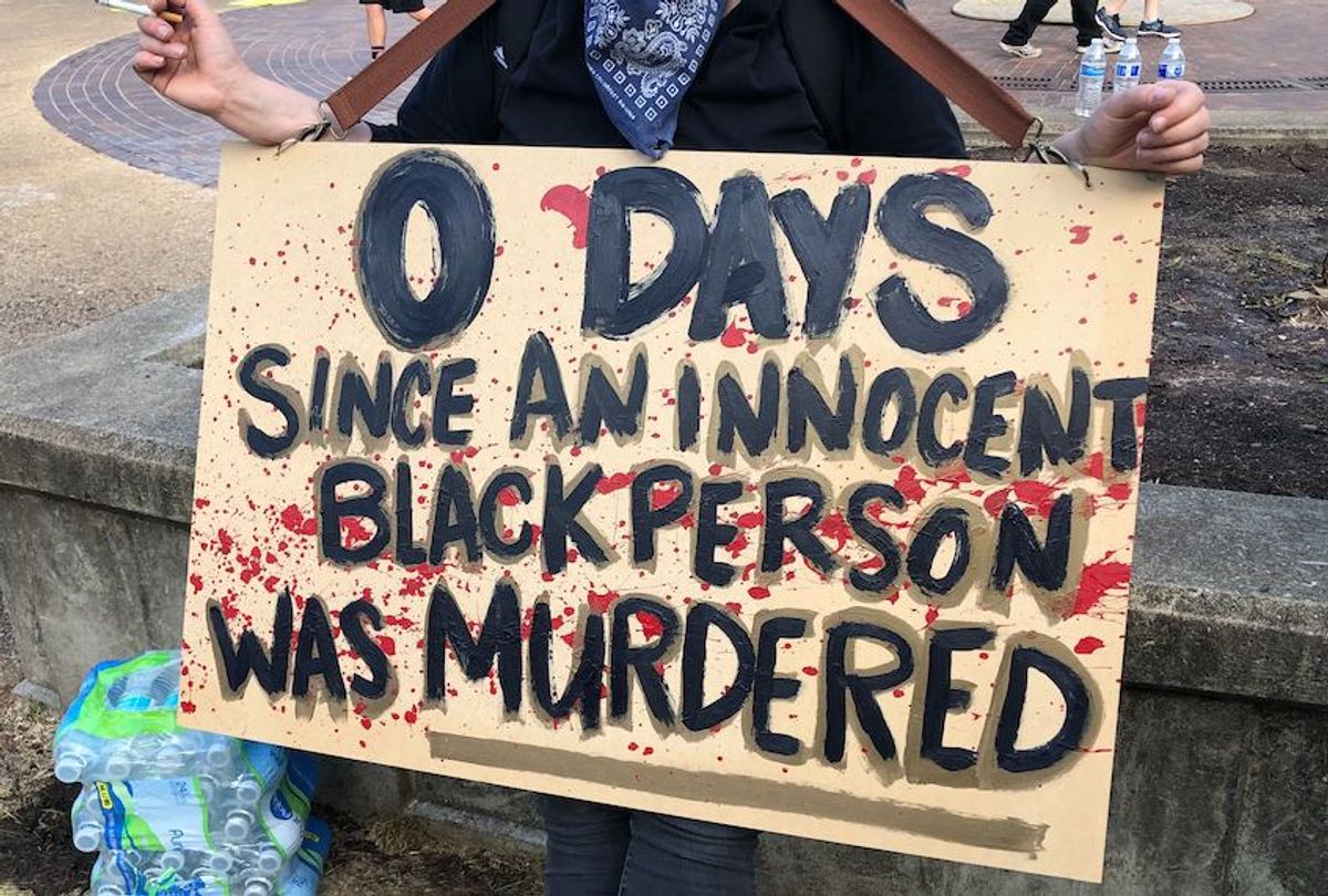 A protester holds up a sign in downtown Louisville, Ky., on June 1, 2020.  (Erin Keane/Salon)