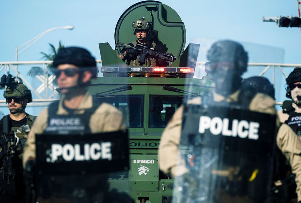 A Miami Police officer watches protestors from a armored vehicle during a rally in response to the recent death of George Floyd in Miami, Florida on May 31, 2020. (RICARDO ARDUENGO/AFP via Getty Images)