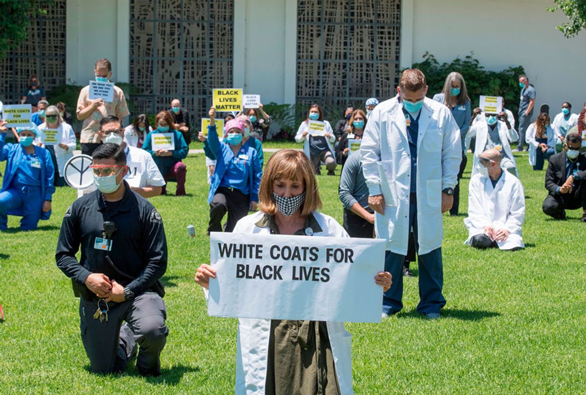Doctors, nurses and other health care workers participate in a "White Coats for Black Lives" event in solidarity with George Floyd and other black Americans killed by police officers, at the Queen of the Valley Hospital in West Covina, California on June 11, 2020 (MARK RALSTON/AFP via Getty Images)
