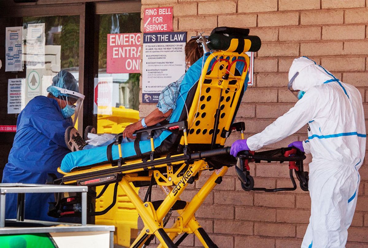 A patient is taken from an ambulance to the emergency room of a hospital in the Navajo Nation town of Tuba City, in Arizona (MARK RALSTON/AFP via Getty Images)