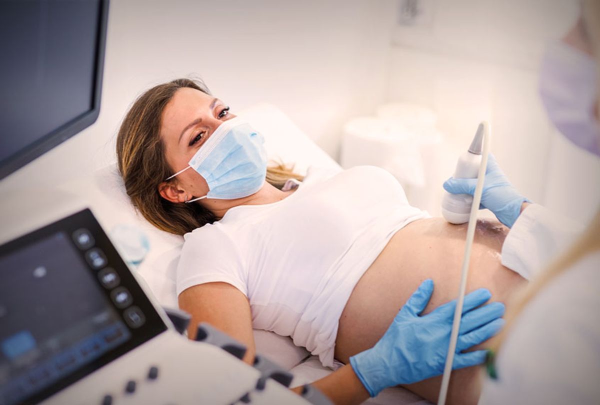 Ultrasound pregnancy examination of a young woman in a Medical Clinic during COVID-19 outbreak (Getty Images)