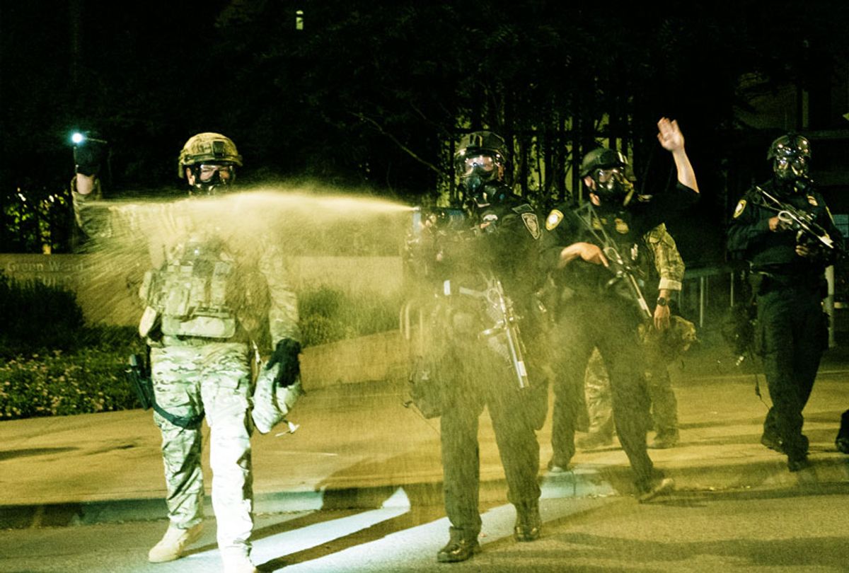 Federal officers use tear gas and other crowd dispersal munitions on protesters outside the Multnomah County Justice Center on July 17, 2020 in Portland, Oregon. Federal law enforcement agencies attempt to intervene as protests continue in Portland. (Mason Trinca/Getty Images)
