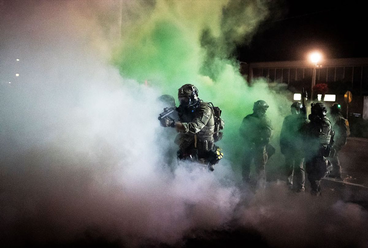 Federal officers walk through tear gas during a dispersal of about 300 protesters in front of the Immigration and Customs Enforcement (ICE) detention building on August 26, 2020 in Portland, Oregon. Protests continued for the 91st night in Portland as activist called for solidarity with rallies in Kenosha, Wisconsin. (Nathan Howard/Getty Images)