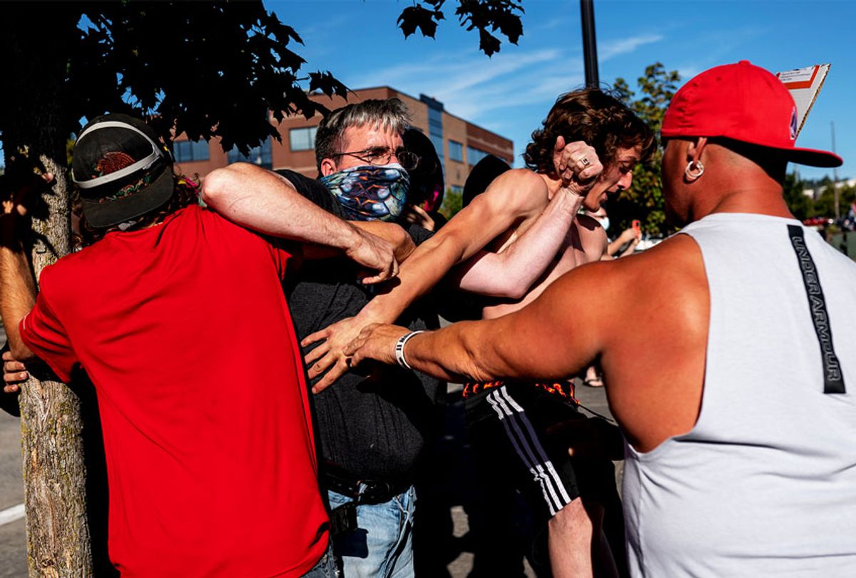 A black Lives Matter protester scuffles with attendees of a pro-Trump rally during an event held to show support for the president on August 29, 2020 in Clackamas, Oregon. Far left counter-protesters and pro-Trump supporters clashed Saturday afternoon as a parade of cars carrying right wing supporters made their way from nearby Clackamas to Portland. (Nathan Howard/Getty Images)