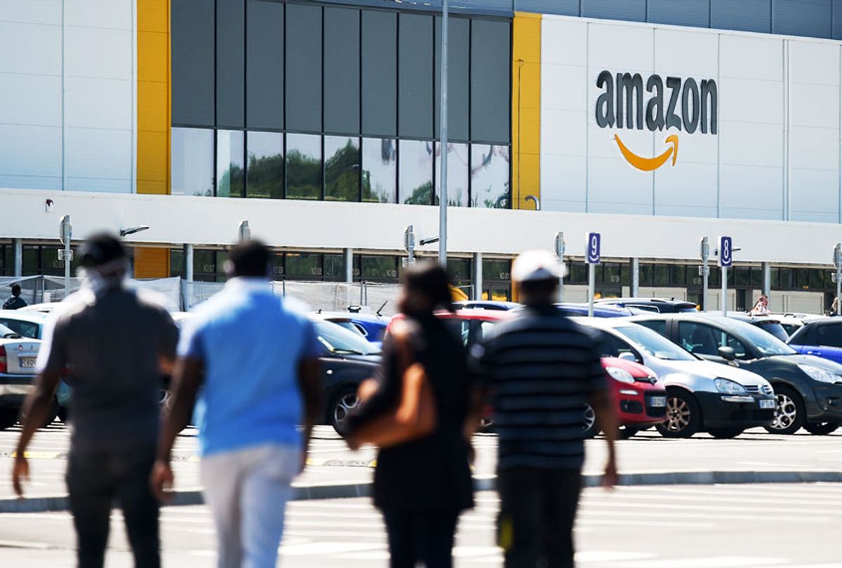 Amazon workers arrive at the company's warehouse (ERIC PIERMONT/AFP via Getty Images)