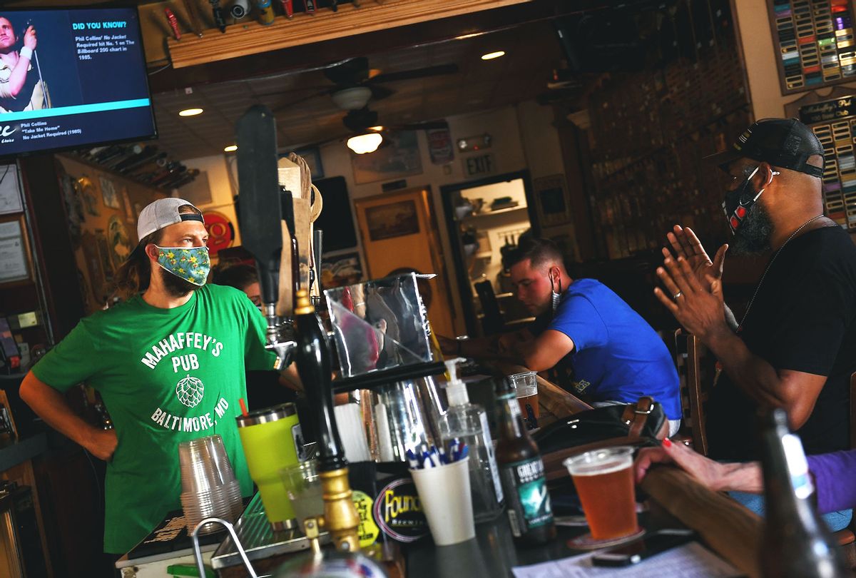Dennis Kistner, owner of Mahaffreys Pub in Canton chats with customers from behind the bar July 23, 2020 in Baltimore, MD. With spikes in coronavirus infections, restaurants and bars in Baltimore have to close down indoor seating Friday. (Photo by  (Katherine Frey/The Washington Post via Getty Images)