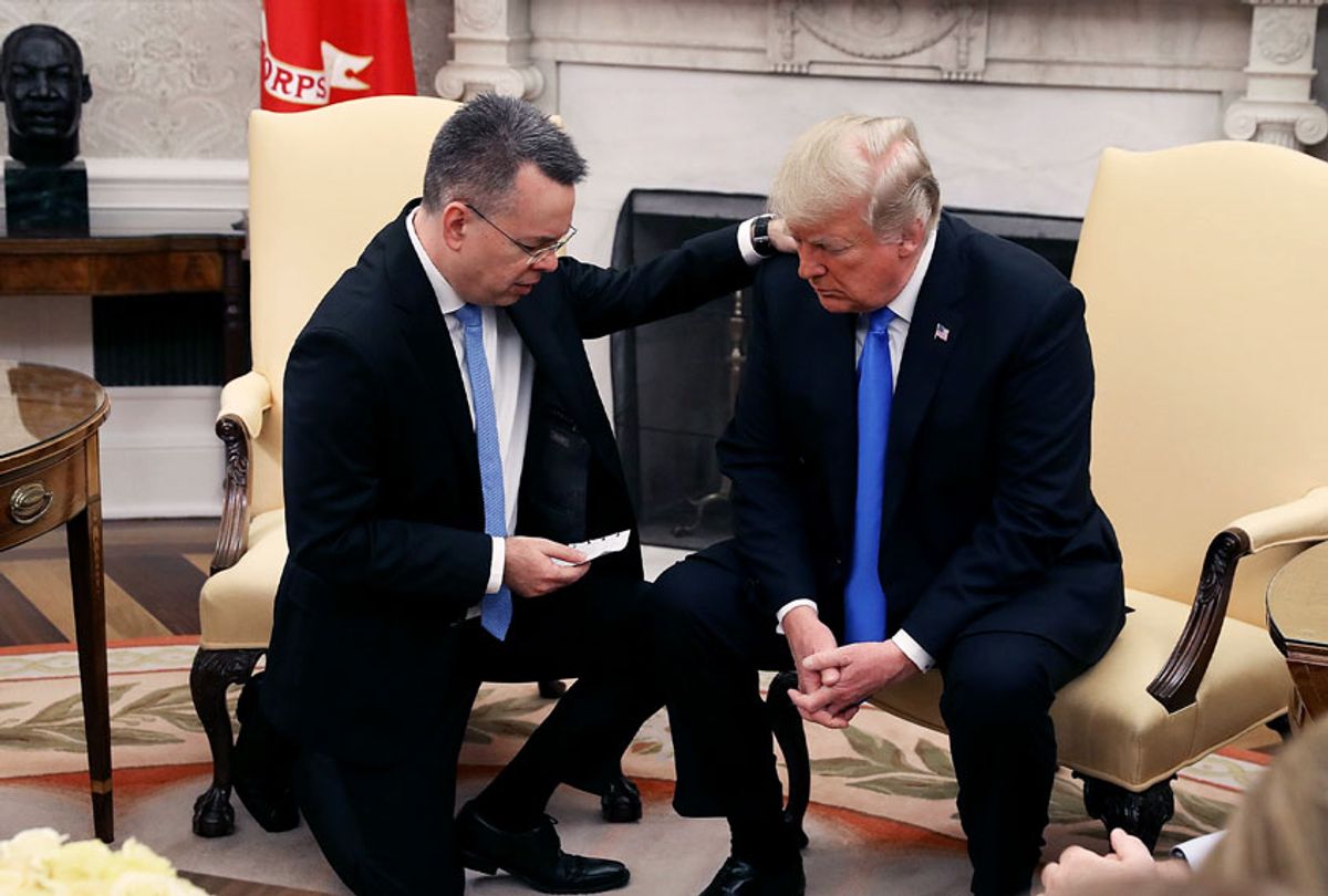 U.S. President Donald Trump and American evangelical Christian preacher Andrew Brunson (L) participate in a prayer in the Oval Office a day after Brunson was released from a Turkish jail, at the White House on October 13, 2018 in Washington, DC. Brunson was detained for two years in Turkey on espionage and terrorism-related charges that the pastor said were false. (Mark Wilson/Getty Images)