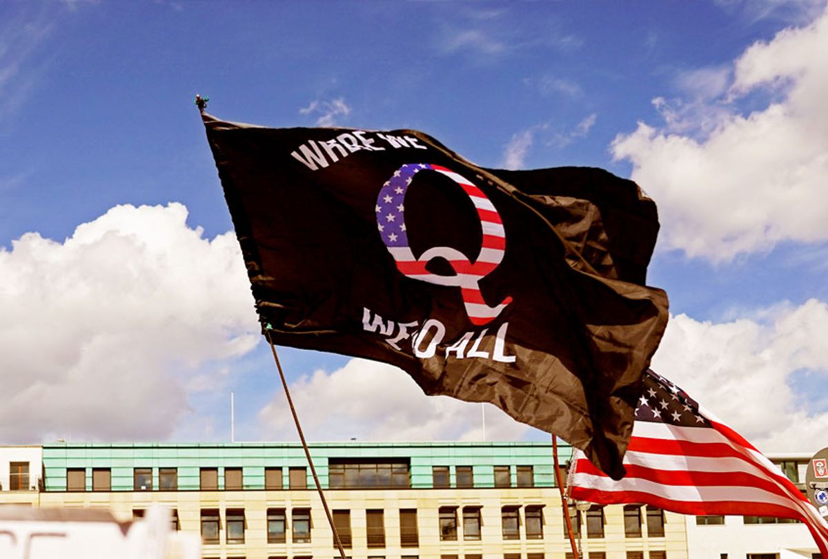 A man waves a QAnon conspiracy flag at a protest of coronavirus skeptics, right-wing extremists and others angry over coronavirus-related restrictions and government policy on August 29, 2020 (Sean Gallup/Getty Images)