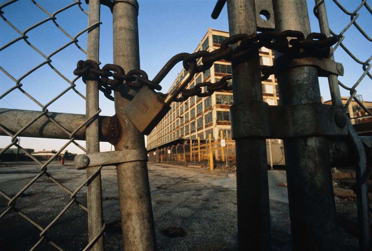 Rusty padlock and chain on gates of closed automobile plant (Getty Images)