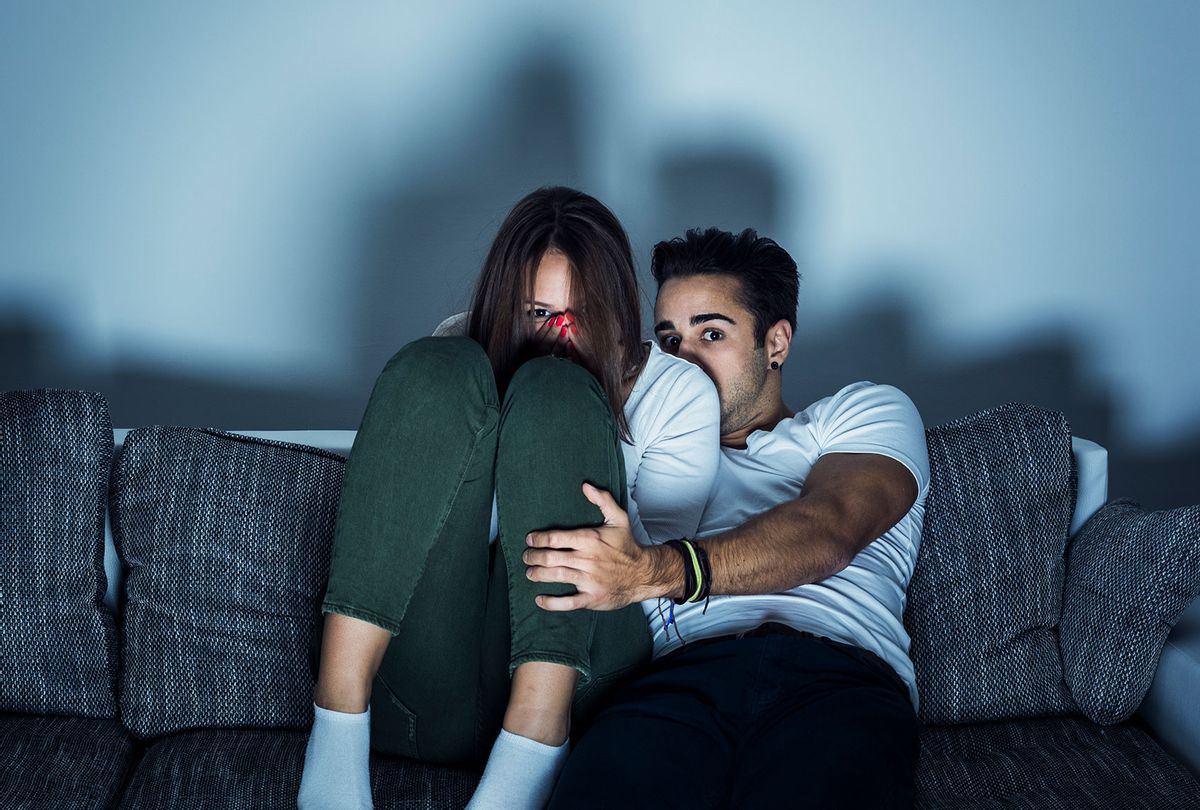 Couple watching scary movie on the couch (Getty Images)