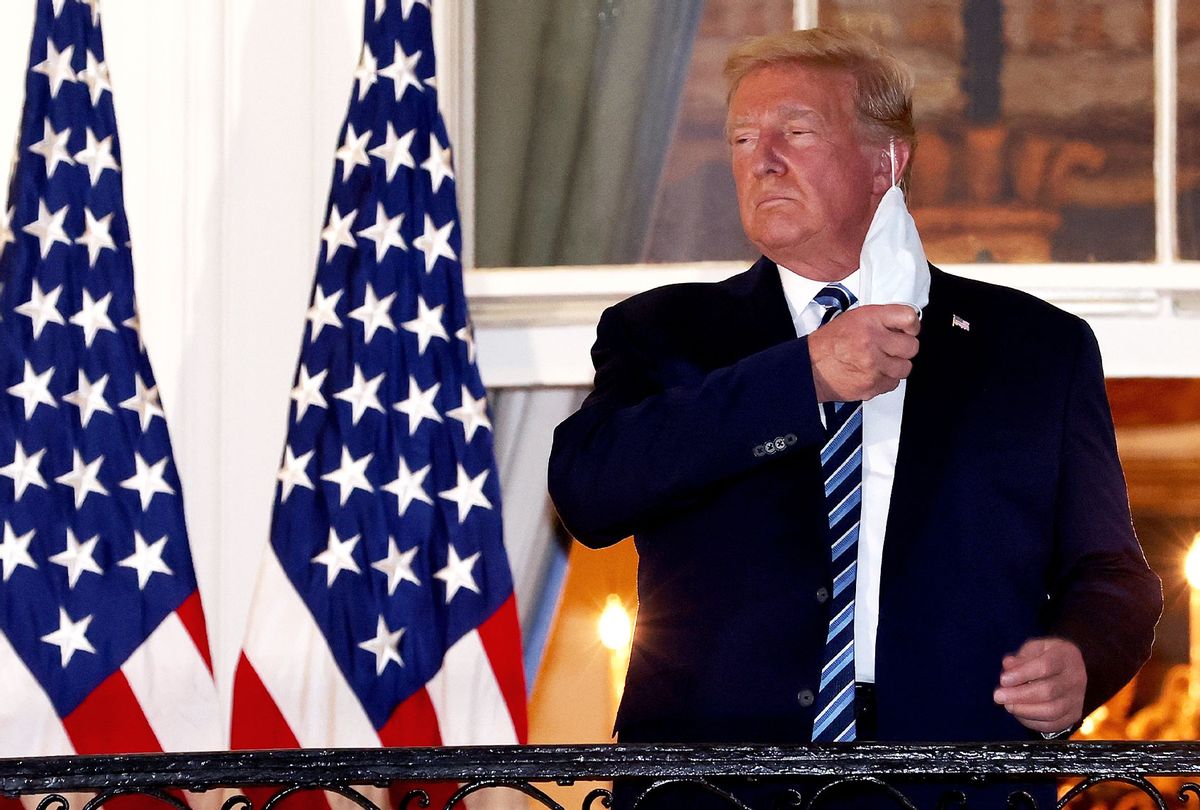 U.S. President Donald Trump removes his mask upon return to the White House from Walter Reed National Military Medical Center on October 05, 2020 in Washington, DC. Trump spent three days hospitalized for coronavirus. (Win McNamee/Getty Images)
