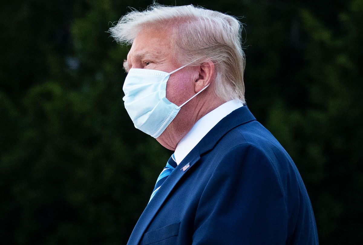 US President Donald Trump wears a facemask as he leaves Walter Reed Medical Center in Bethesda, Maryland heading to Marine One on October 5, 2020, to return to the White House after being discharged. (SAUL LOEB/AFP via Getty Images)